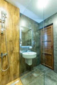 a bathroom with a sink and a glass shower at Maestro Rest House Dilijan in Dilijan +43 photos