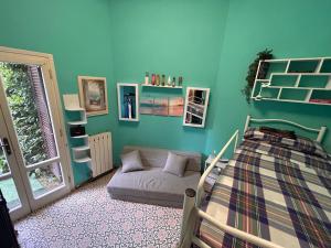 a bedroom with blue walls and a bed and a window at Villino Arsella in Marina di Pietrasanta