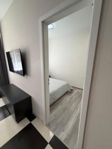 a mirror in a room with a bed at Морской Двор in Chornomorsk +118 photos