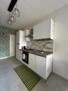 a kitchen with white cabinets and a sink at Alla Chiesetta in Naples