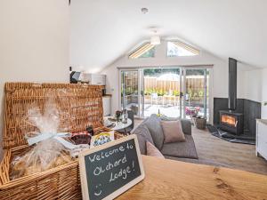 a living room with a table with a sign on it at Olchard Lodge in Newton Abbot