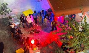 a group of people standing around a room with red flowers at Moon Palace by MZ Hotels Pakistan KPK in Mingāora
