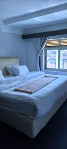 a bedroom with a large bed with a window at Kaa Highway Hotel Mukono in Mukono
