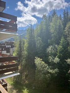 a view from the balcony of a house with trees at B&B cot in La Ferrière