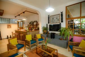 a living room with colorful chairs and a bar at Gassy Country House Ivato Airport in Ivato