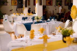 a group of tables with white chairs and flowers at Gassy Country House Ivato Airport in Ivato +72 photos