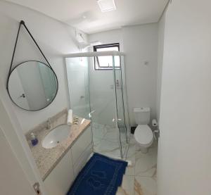 a bathroom with a sink and a mirror and a toilet at Apartamento Crisalidas em Foz in Foz do Iguaçu +32 photos