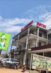 a hotel with a car parked in front of it at Kaa Highway Hotel Mukono in Mukono