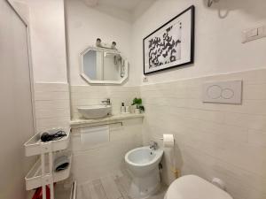 a white bathroom with a sink and a toilet at Lake Suite in Trevignano Romano +34 photos