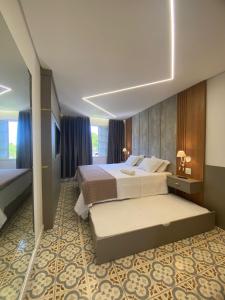 a hotel room with a bed and a television at Hotel Morro dos Conventos in Araranguá +77 photos