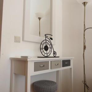 a white table with a white mirror and a bicycle on it at Discovery Tavira in Tavira