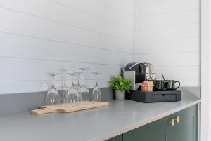 a kitchen counter with several wine glasses on it at AvantGlamp in Marston Green