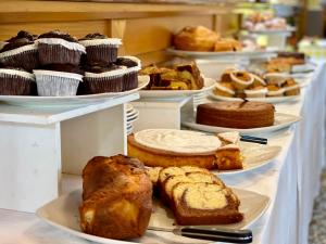 a display of different types of bread and pastries on plates at Botte dei Benandanti in Vivaro
