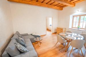a living room with a couch and a table at Mlýn Propast in Stříbrná Skalice