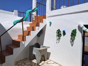 a staircase with plants on the side of a building at Casa Benlindha in Degolados