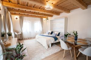 a bedroom with a bed and a table and chairs at Mlýn Propast in Stříbrná Skalice