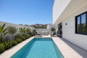 a swimming pool in the backyard of a house at 6BR luxury villa with Pool & Hot tub - 2Living rooms & 10Bathrooms in Tal-Għoqod
