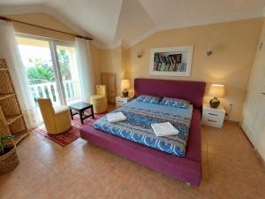 a bedroom with a purple bed in a room at Dalyan Palace in Dalyan