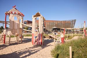 a park with a playground with a slide at RCN Vakantiepark de Schotsman in Kamperland