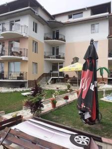 an umbrella on a table in front of a building at Sunshine in Byala