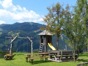 a playground with a slide and a bench and a swing at Appartement Andi in Wagrain