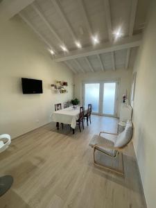 a large living room with a table and chairs at Camere LaVigna in Carrara