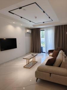 a living room with a couch and a table at Royal Rooms by J'adore in Lugoj