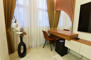 a room with a desk and a vase with flowers in it at Dream Palace 1 in Belgrade