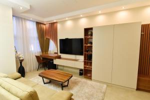 a living room with a couch and a table at Dream Palace 1 in Belgrade