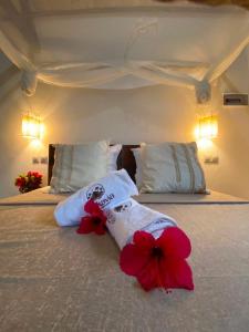 a bedroom with two beds with flowers on it at ANKAVIA Lodge in Toamasina