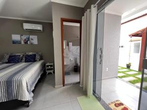 a bedroom with a bed and a bathroom at Pousada Recanto Sossego in Saquarema