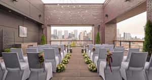 a room with white chairs and white flowers at Hyatt House Chicago West Loop-Fulton Market in Chicago +40 photos
