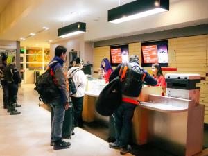 a group of people waiting at a counter in a restaurant at ibis Antofagasta in Antofagasta