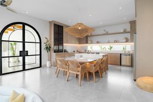 a kitchen with a table and chairs in a room at Casa Contenta Canggu - Luxury 5BR Private Pool Villa in Canggu