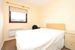 a bedroom with a white bed and a window at Glasgow West End Accommodation in Glasgow