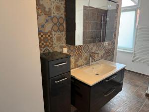a bathroom with a sink and a mirror at Stangenberg`s City Loft in Hameln +16 photos