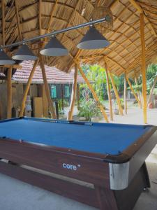 a pool table in front of a pavilion at Funky Monkey Surfhostel Hiriketiya in Hiriketiya