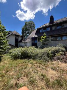 a person sitting in front of a house at Waldgarten Marienau in Höchenschwand