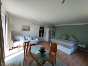 a living room with a bed and a couch at Appartement Weideblick in Steinsieken