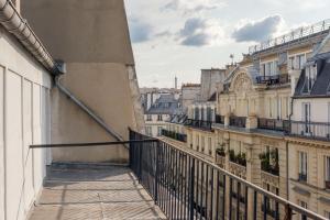 a balcony with a view of the city at Get My Hatch Bergère in Paris