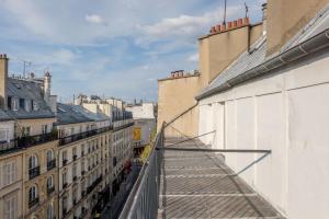 a view of a city from a balcony of a building at Get My Hatch Bergère in Paris +29 photos