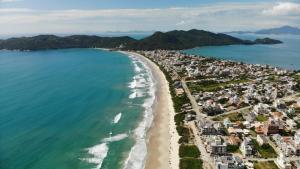 an aerial view of a beach and the ocean at Refúgio dos Guaiás - Apart Hotel in Bombinhas +258 photos