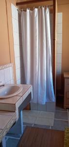 a bathroom with a white shower curtain and a sink at Chambres d'Hôtes de La Vallée Du Serein in Annay-sur-Serein +74 photos
