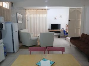a living room with a couch and a table at Residencia BB in Praia