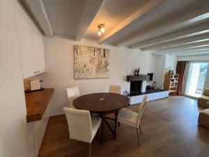 a kitchen and dining room with a table and chairs at Slope-Side Mountain Apt Sleeps 4 in Laax