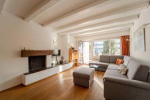 a living room with a couch and a fireplace at Slope-Side Mountain Apt Sleeps 4 in Laax