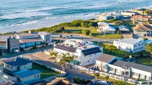 an aerial view of a coastal town with the ocean at Withuis Hartenbos - No Load Shedding in Hartenbos