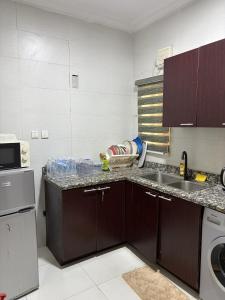 a kitchen with a sink and a counter top at The Luxe Haven in Lekki Phase 1