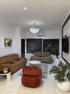 a living room with a couch and a table at The Luxe Haven in Lekki Phase 1