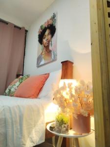 a bedroom with a bed and a table with a lamp at Carribean Boutique Hostel in San José